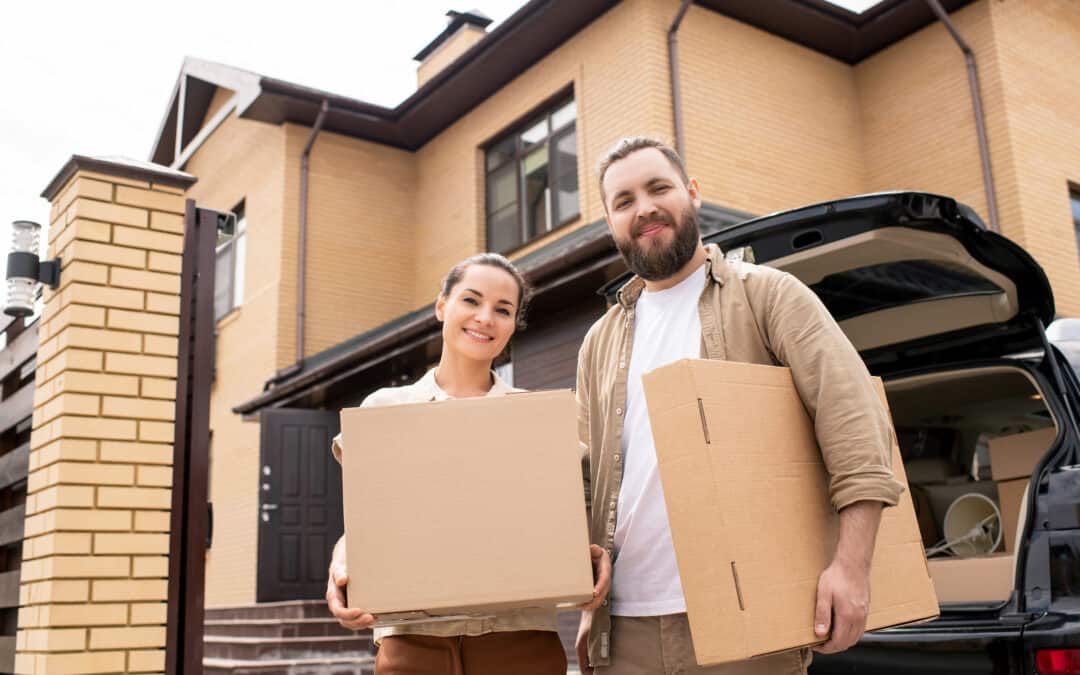 Portrait of positive young couple have bought of dream home standing with moving boxes